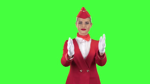 Stewardess Shows with a Gesture That Everyone Would Stay on the Ground. Green Screen