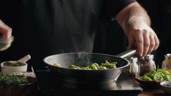 Chef Frying Green Brussels Sprouts Cabbage in Pan Closeup