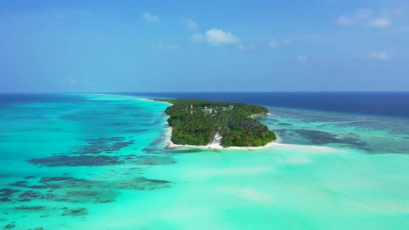Daytime aerial island view of a sandy white paradise beach and blue sea background in colourful 4K