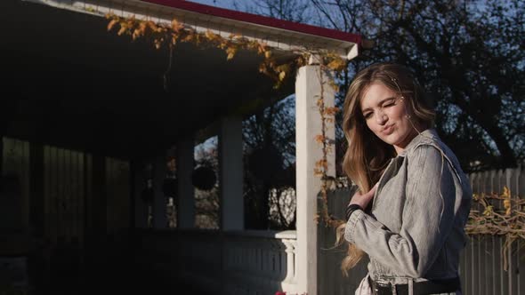 Beautiful Fashionable Model Soft Smiles, Posing Outdoors. Charming Blonde Look in Slow Motion