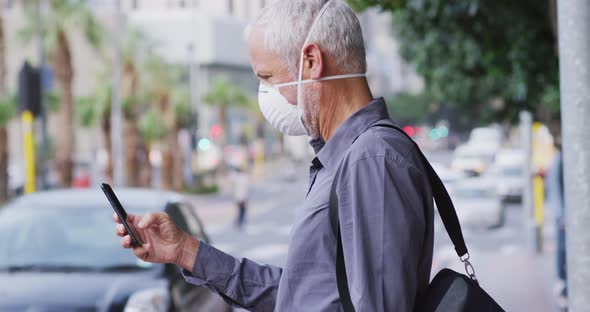 Caucasian man out and about in the street wearing on a face mask against coronavirus