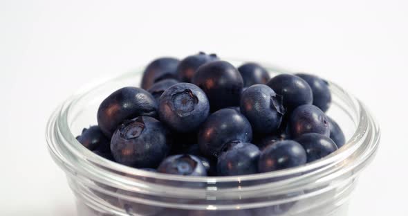 Blueberries In Glass Bowl Moving Across White Background Loop