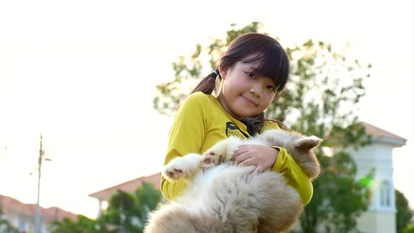 Cute Asian Girl Playing With Siberian Husky Puppy In The Park