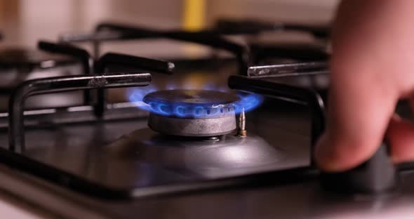 Natural gas burning on kitchen gas stove alt