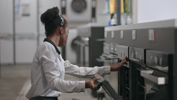 Afro American Housewife is Buying Electric Oven in Home Appliances Store Female Shopper is Comparing