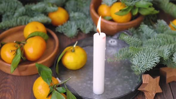 Christmas Decor on a Wooden Background. Tangerines, Candles Next To the Branches of the Christmas