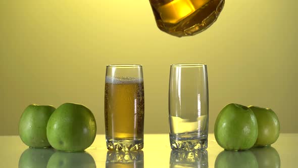 Pouring Apple Juice Into the Glasses