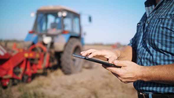 Farmer is Using Digital Tablet