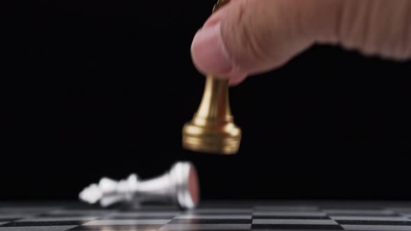 Close up of male hand moving gold king chess for defeating opponent, Game of Chess. Leader and Teamw