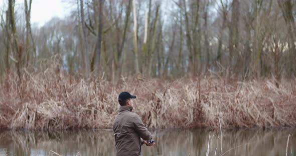 Fisherman Holding Fishing Rod in Hands