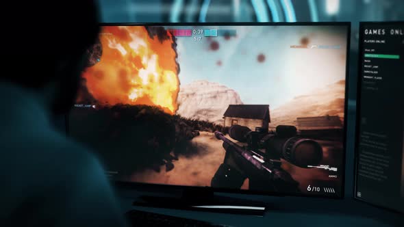 A gamer is shooting explosive barrels in an internet computer warfare video game alt