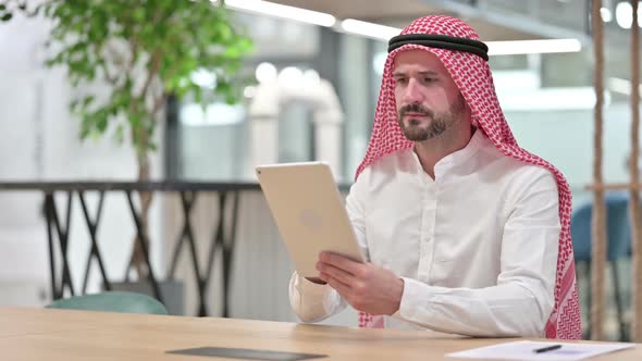 Serious Professional Arab Businessman Using Tablet
