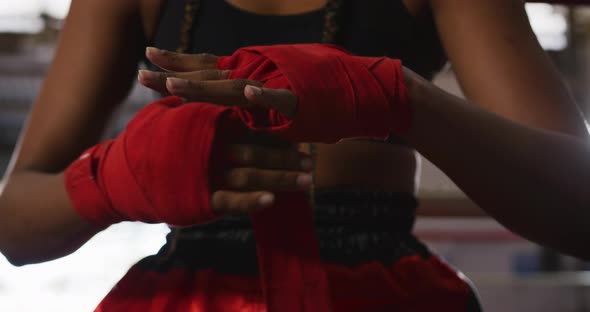 Mixed race woman wrapping her hands