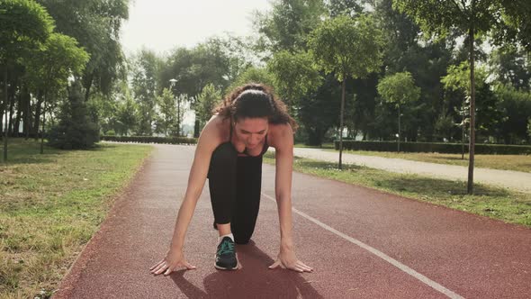 Athletic Woman Getting Ready to Start Outdoor