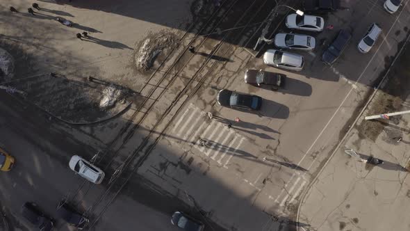 Top View Of People Crossing The Road At Sunset