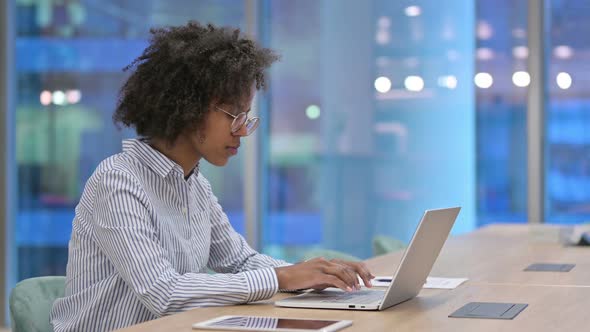 Focused African Businesswoman Working on Laptop in Office 