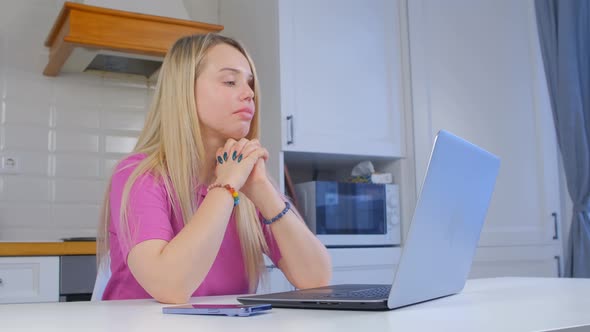 Professional freelance thinking about work in front of laptop computer in closeup 4k video