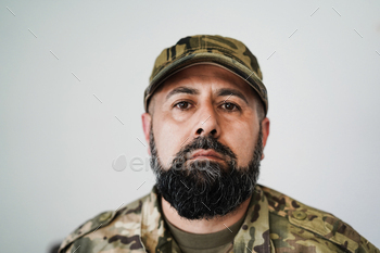 Serious male soldier looking at camera - Focus on cap