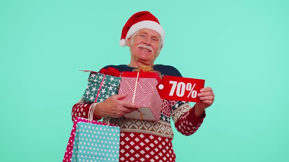 Mature Man in Christmas Sweater Showing Gift Box and 70 Percent Discount Inscriptions Banner Text