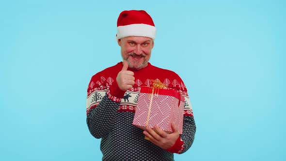 Cheerful Man in Sweater Santa Christmas Hat Getting Present Gift Box Expressing Amazement Happiness