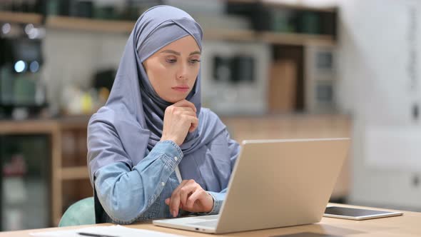 Young Arab Woman with Laptop Thinking at Work 