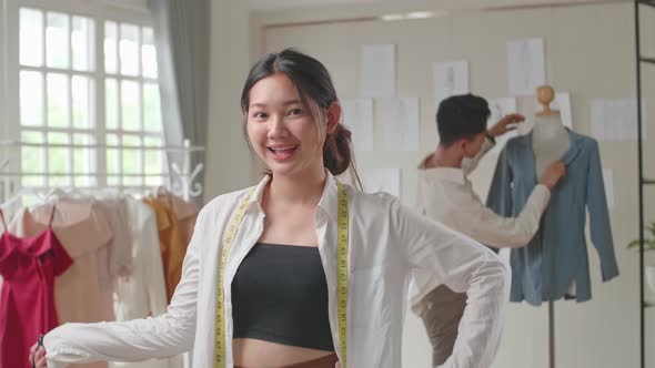 Young Asian Woman Tailor Holding Scissor And Smiling