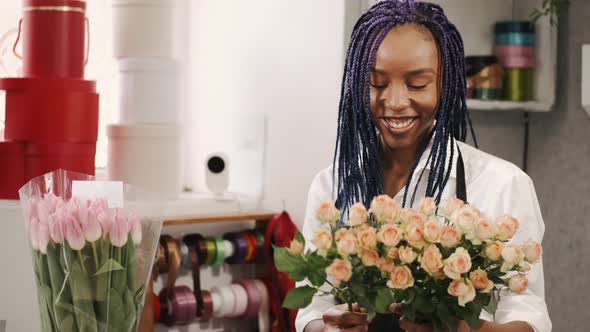Happy Positive African Woman Making Composition From Roses