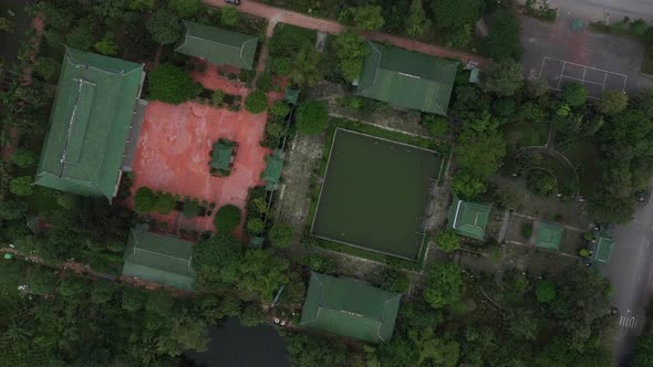 aerial top down rotation of ancient Buddhist temple and gardens in south Vietnam