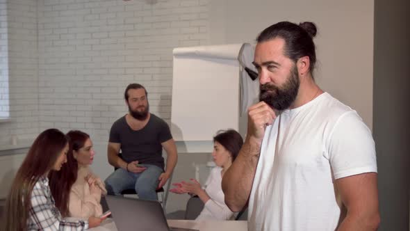 Mature Handsome Bearded Businessman Smiling Thoughtfully To the Camera