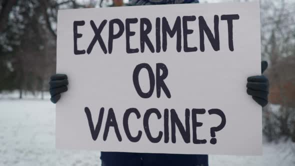 Close-Up Of Slogan Banner On Protest Against Recently Developed Medical Vaccine