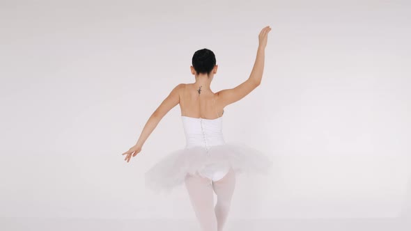 Woman Dancing Gracefully in Ballet Studio