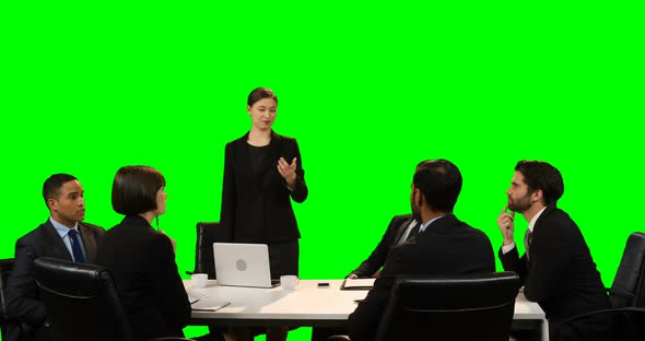 Businesswoman touching invisible screen during meeting