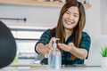 Asian woman using hand sanitizer when working at home with technology laptop - PhotoDune Item for Sale