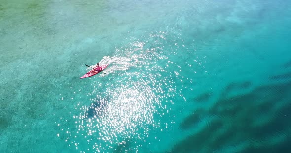 Aerial view of woman kayaking on a lake 4k