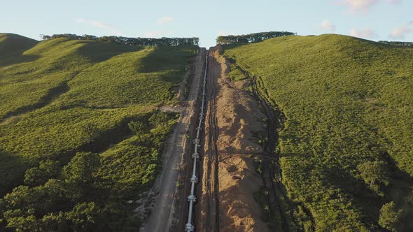 Laying the Main Gas Pipe in a Dug Trench Among the Mountains