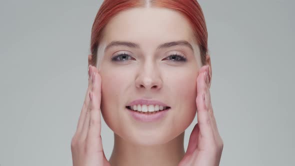 Studio portrait of young, beautiful and natural redhead woman. Beauty concept.