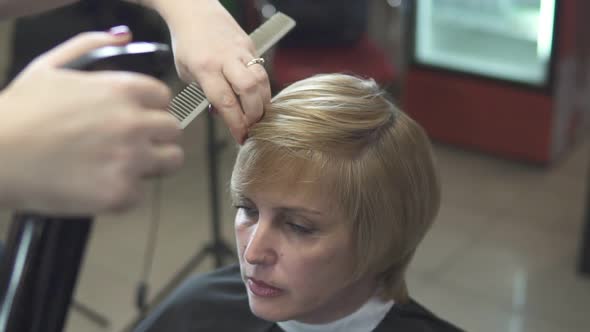 Young Woman Getting Her Hair Dressed in Hair Salon