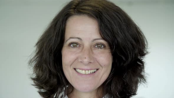 Happy Middle Aged Woman with Green Eyes Looking at Camera