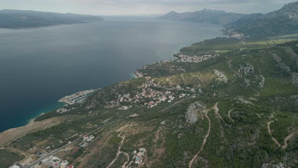 A Drone View of a Mountain Road and a Small Coastal Town in the Makarska Riviera Region of Croatia