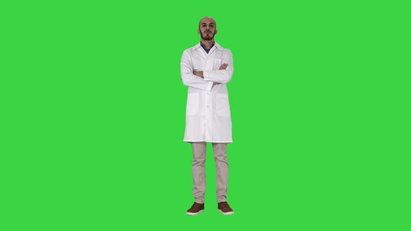 Serious Arabian Doctor Mature Male with Crossed Arms on a Green Screen, Chroma Key.