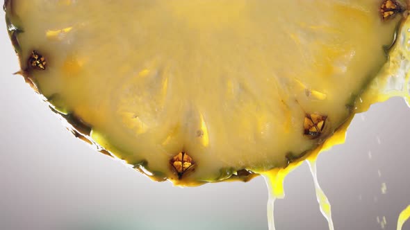 Flowing Pineapple Juice From Pineapple Slice Macro Shot in Slow Motion