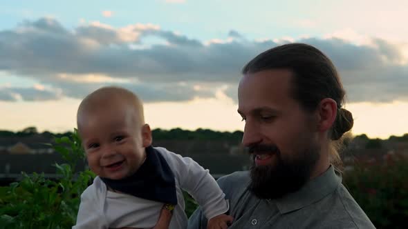 Happy Father Holding Adorable Baby Boy Embracing Kissing