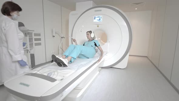 The Doctor Performs an MRI Scan for a Patient at the Clinic