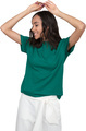 a woman wearing a green top and white pants with her hands on her head - PhotoDune Item for Sale