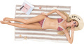 a woman laying on a beach towel with a hat and a book - PhotoDune Item for Sale