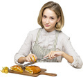 a woman in an apron cutting food with a knife and fork - PhotoDune Item for Sale