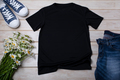 Black T-shirt mockup with daisy flowers and jeans - PhotoDune Item for Sale