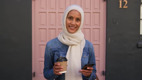 Young woman wearing hijab out and about in the city