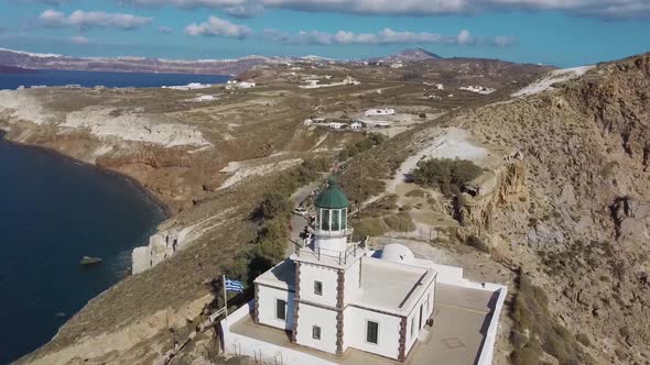 4k aerial drone flying over beautiful lighthouse Santorini Greece