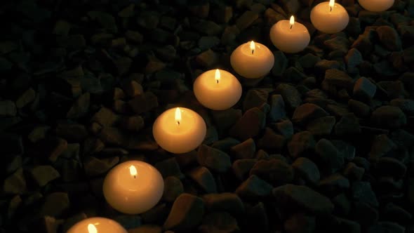 Passing Row Of Candles On The Rocks